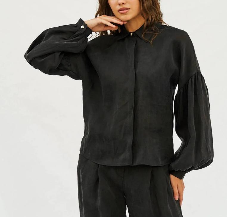 Model in black blouse and trouser look from Rhyme & Hype