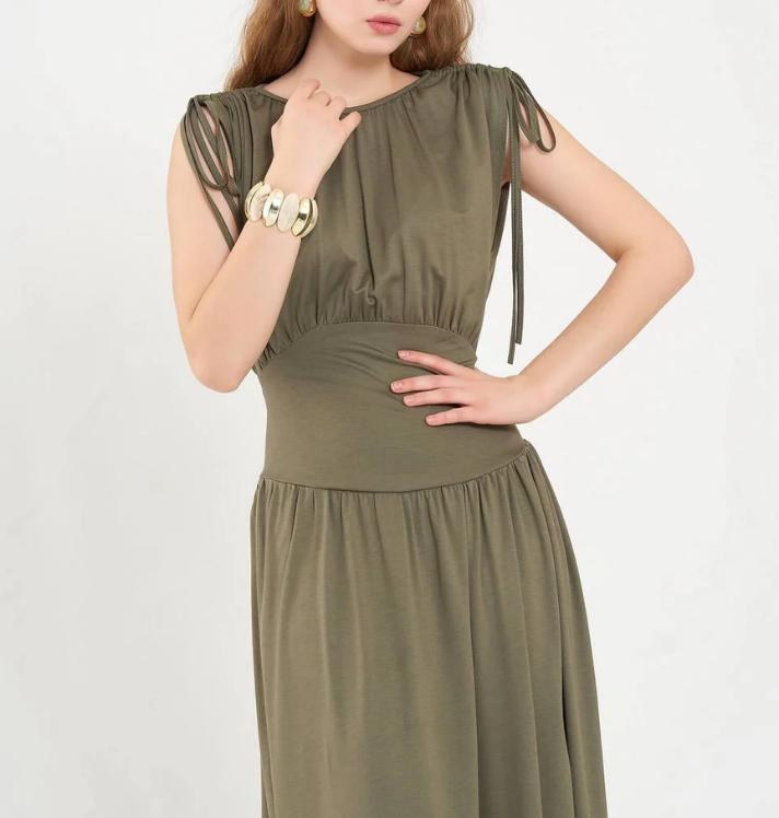 Model in olive sleeveless dress from Rhyme & Hype